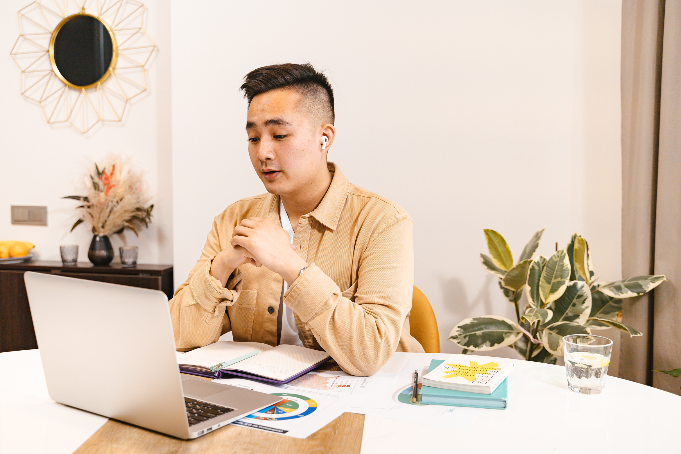 Man Wearing Brown Long Sleeves Polo Using a Laptop